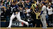  ?? AP PHOTO BY JEFF ROBERSON ?? Milwaukee Brewers’ Brandon Woodruff celebrates after hitting a home run during Game 1 of the National League Championsh­ip Series Friday, Oct. 12.