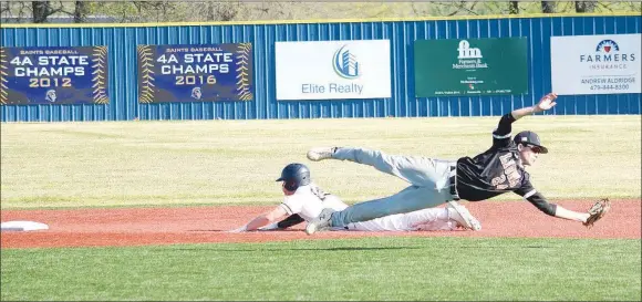  ?? Westside Eagle Observer/MIKE ECKELS ?? Lion McCoy Kildow makes a diving catch as the Saints base runner slides toward second base during the Shiloh Christian-Gravette conference contest in Springdale Friday night. The Saints runner was called safe at second base by the infield umpire.