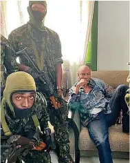  ?? Photo: EPA ?? Soldiers detain Alpha Conde during the coup last year.