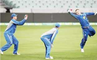  ??  ?? ADELAIDE: Austalia’s Peter Nevill, right, reaches for a ball during training at the Adelaide Oval ahead of their cricket test against New Zealand in Adelaide, yesterday. The test starting tomorrow will be the first ever day/night cricket test match.