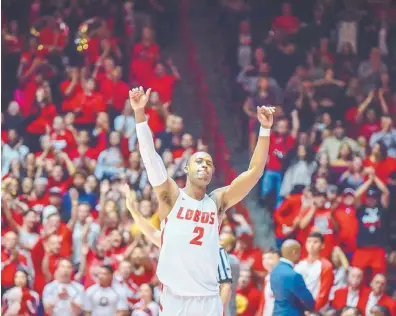 ?? ROBERTO E. ROSALES/JOURNAL ?? Sam Logwood waves goodbye to the Dreamstyle Arena crowd as he walks off the court for the last time for New Mexico. The Lobos fought off Fresno State’s late surge to win the regular-season finale 95-86 on Saturday.