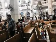  ?? NARIMAN EL-MOFTY / AP ?? People look over the damage inside St. George’s Church after Sunday’s suicide bombing in Tanta, Egypt. That bomb killed at least 27 people.