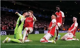  ?? Photograph: Zac Goodwin/PA ?? Arsenal players race towards their goalkeeper David Raya after his second shootout save sealed their Champions League progress.