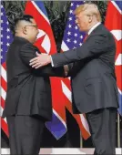  ?? Evan Vucci ?? The Associated Press President Donald Trump shakes hands Tuesday with North Korean leader Kim Jong Un at the Capella resort on Sentosa Island, Singapore.