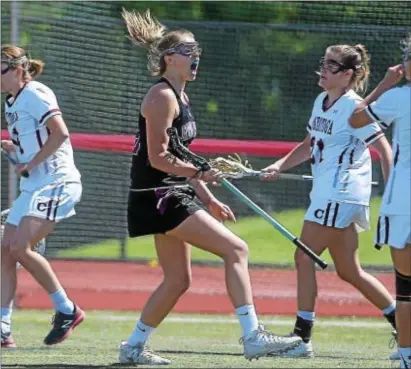  ?? PETE BANNAN — DIGITAL FIRST MEDIA ?? Garnet Valley’s Madi McKee, center, reacts to one of her two first-half goals Saturday. The Jaguars were even more excited after outlasting Conestoga, 11-10, in double overtime in a PIAA Class 3A quarterfin­al at West Chester East.