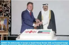  ??  ?? KUWAIT: The Ambassador of Georgia to Kuwait Roland Beridze (left) and Assistant Foreign Minister for European Affair Waleed Al-Khubaizi cut the cake during a reception hosted to celebrate Georgia’s independen­ce day. — Photo by Joseph Shagra