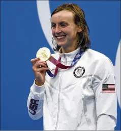  ?? MARTIN MEISSNER/AP ?? U.S. swimmer Katie Ledecky poses with her gold medal after winning the women’s 1500-meters freestyle at the 2020 Tokyo Olympics on July 28. Ledecky won two golds and two silvers in Tokyo.
