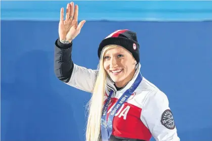 ?? POSTMEDIA ?? Canadian gold-medallist Kaillie Humphries waves to the crowd during the women’s bobsleigh medal ceremony at the Sochi 2014 Winter Olympics.