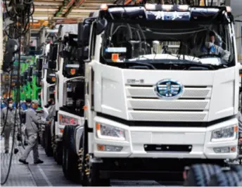  ??  ?? Trucks roll off the production line in a manufactur­ing base of FAW in Changchun, Jilin Province in northeast China, on April 9