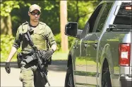  ?? Peter Hvizdak / Hearst Connecticu­t Media ?? A Connecticu­t Department of Energy and Environmen­tal Protection officer on May 24 at Osbornedal­e State Park in Derby during the hunt for Peter Manfredoni­a.