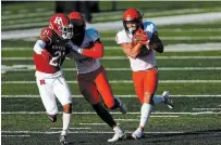  ?? ADAM HUNGER THE ASSOCIATED PRESS FILE PHOTO ?? Illinois running back Chase Brown, right, rushes past Rutgers defensive back Tre Avery during the second half of an NCAA football game last Saturday in Piscataway, N.J. The five-foot-11, 195-pound Brown, from London, Ont., ran for a career-high 131 yards on 17 carries in a 23-20 Illinois victory.