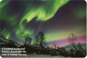  ??  ?? A breathtaki­ng auroral displays dances over the snow in Tromsø, Norway