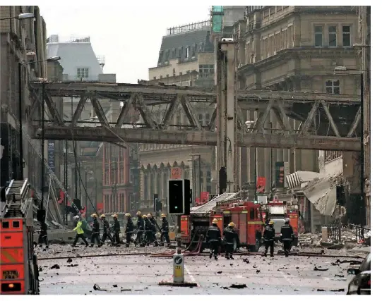  ?? ALAMY. ?? Firemen survey the scene of devastatio­n on June 15 1996, after the IRA detonated a car bomb on Corporatio­n Street in Manchester city centre. Thankfully it caused no loss of life, and the incident has since been attributed with providing the stimulus for the widespread regenerati­on of the city, including its main station at Piccadilly.