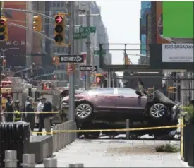  ?? MARY ALTAFFER — ASSOCIATED PRESS ?? The car that mowed down pedestrian­s in Times Square on Thursday rests against a security barrier after the incident.