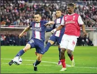  ?? France. (AP) ?? PSG’s Pablo Sarabia (left), is challenged by Reims’ Emmanuel Agbadou during a French League One soccer match between Reims and Paris Saint-Germain, at the Stade Auguste-Delaune in Reims, eastern