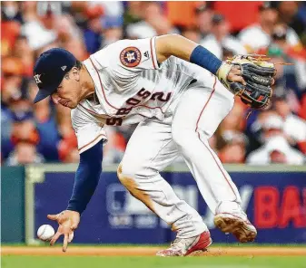  ?? Karen Warren / Staff photograph­er ?? Alex Bregman bare hands a grounder from Boston’s Mookie Betts before throwing him out during the seventh inning of Game 3 of the American League Championsh­ip Series on Tuesday.