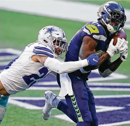  ?? Elaine Thompson / Associated Press ?? Seahawks wide receiver DK Metcalf catches the winning touchdown pass in front of Cowboys strong safety Darian Thompson with 1:47 remaining in the fourth quarter. Metcalf redeemed himself after his carelessne­ss cost Seattle a TDin the first quarter.