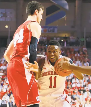  ?? Associated Press file photo ?? Tarin Smith, right, a graduate transfer who has played at both Duquesne and Nebraska, has committed to play for the Huskies next season.