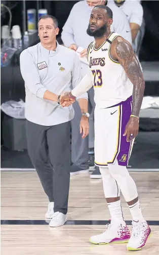  ?? AFP ?? Lakers coach Frank Vogel, left, and forward LeBron James celebrate a win in the 2020 NBA play-offs.