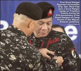  ?? KRIZJOHN ROSALES ?? First Scout Ranger Regiment commander Brig. Gen. Rene Paje pins a Scout Ranger badge on President Duterte during the 67th anniversar­y of the Scout Rangers at Camp Tecson in San Miguel, Bulacan yesterday.