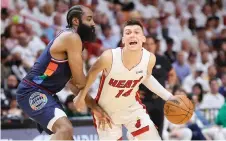  ?? — AFP photo ?? Tyler Herro of the Miami Heat drives to the basket against James Harden of the Philadelph­ia 76ers.