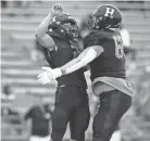  ?? JOE RONDONE/THE COMMERCIAL APPEAL ?? Houston’s Ben Stegall, left, celebrates his touchdown with teammate
Harrison Wilks during their game against Christian Brothers at Landers Ford Stadium on Friday, Aug. 21, 2020.