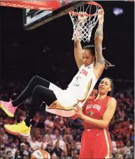  ?? John Locher / Associated Press ?? Phoenix Mercury’s Brittney Griner, of Team Delle Donne, dunks over Las Vegas Aces’ Liz Cambage, of Team Wilson, during the first half of a WNBA All-Star game in 2019 in Las Vegas. Griner is one of six returning Olympians on this year’s Olympic roster.