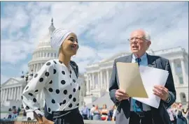  ?? Jim Lo Scalzo EPA/Shuttersto­ck ?? SEN. BERNIE SANDERS, with Rep. Ilhan Omar (D-Minn.), is proposing to eliminate all outstandin­g student debt held by Americans, regardless of income.