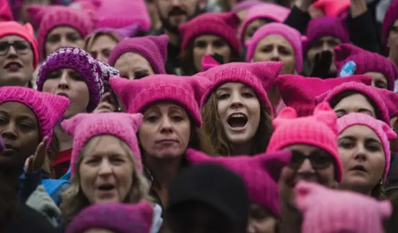 ?? AMANDA VOISARD/THE WASHINGTON POST ?? Thousands of women wore pink “pussyhats” as a symbolic protest, recalling Donald Trump’s crude words toward women that became an issue in the divisive campaign.