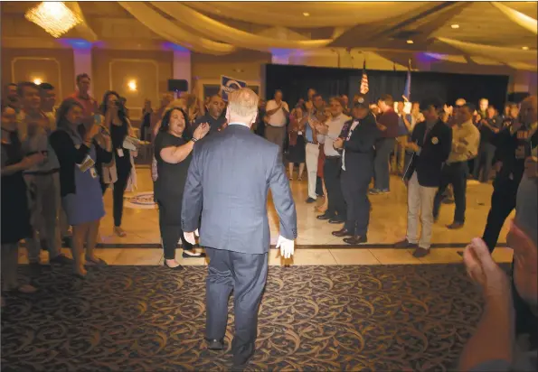  ?? H John Voorhees III / Hearst Connecticu­t Media ?? Above, Danbury Mayor Mark Boughton, the endorsed Republican candidate for governor, walks into the La Bella Vista ballroom to talk to supporters after losing the GOP primary in the governor’s race on Aug. 14 in Waterbury. Below left, a victim is placed on a stretcher and loaded into an ambulance on White Street on July 6. Witnesses said they saw the man dash out of Superior Court and onto the road before a car hit him, flinging the man at least 10 feet in the air. Below right, Connecticu­t State Trooper 1st class Benjamin Pagoni, from Troop A, responds to the Visual &amp; Performing Arts Center on the Western Connecticu­t State University Westside campus after an active shooter was reported on the campus on Nov. 20, in Danbury.