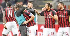  ?? - AFP photo ?? AC Milan’s Italian defender Alessio Romagnoli (C) celebrates with teammates after scoring a goal during the Italian Serie A football match between AC Milan and Genoa at the San Siro stadium in Milan.