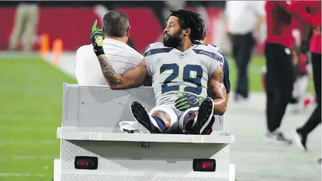  ?? NORM HALL/GETTY IMAGES ?? Seahawks defensive back Earl Thomas makes a recognizab­le gesture toward the Seattle Seahawks’ bench as he leaves the field on a cart after fracturing his leg during the fourth quarter against the Arizona Cardinals at State Farm Stadium on Sunday in Glendale, Ariz.