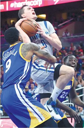 ?? AP FOTO ?? REVERSAL. Mario Hezonja is fouled by Andre Iguodala on his way to the basket during Orlando’s home game against the Warriors. It was the first time for the Warriors to tip off at noon (Eastern time) in more than 20 years. The last time, they lost by 34...
