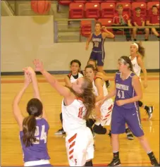  ?? MARK HUMPHREY ENTERPRISE-LEADER ?? Farmington senior Camryn Journagen contests a shot by Berryville’s Baylea Smith. The Lady Cardinal defense hampered Berryville’s perimeter shooting during a Nov. 8 benefit game won, 47-31, by Farmington.