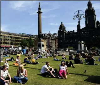  ??  ?? George Square. is a magnet for sun worshipper­s on a hot day Picture: Jamie Simpson
