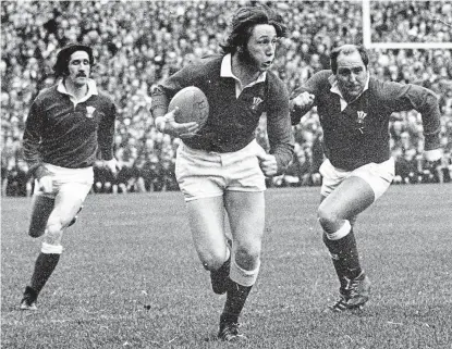  ?? ?? One of a kind: the brilliant JPR Williams plays for Wales with Gerald Davies and Jeff Young in 1971