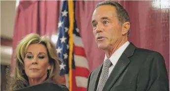  ?? JOHN NORMILE/GETTY IMAGES ?? U.S. Rep. Chris Collins, R-N.Y., with wife Mary at his side Wednesday, promised “a vigorous defense in court to clear my name.”