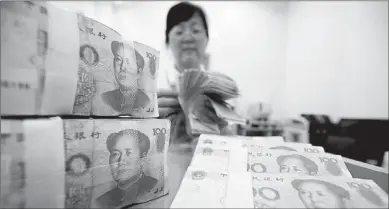  ?? XIE ZHENGYI / FOR CHINA DAILY ?? Yuan-denominate­d deposits among banks dropped by 257.3 billion yuan in July.