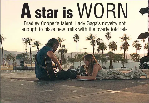  ??  ?? Jackson Maine (Bradley Cooper) picks out a melody for Ally (Lady Gaga) as the two write a song together in A Star Is Born.