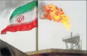  ?? REUTERS/FILE ?? A gas flare on an oil production platform in the Soroush oil fields is seen alongside an Iranian flag in the Persian Gulf, Iran