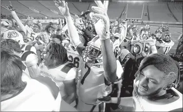  ?? Arkansas Democrat-Gazette/THOMAS METTHE ?? Arkadelphi­a players celebrate after Saturday night’s victory over Joe T. Robinson in the Class 4A championsh­ip game at War Memorial Stadium in Little Rock. The Badgers won their second consecutiv­e state title and their fourth overall.