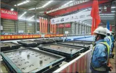  ?? ZU KANAN / XINHUA ?? Production of prefabrica­ted rail plates for the new Jakarta-Bandung line is completed at a factory in Cikampek, West Java.