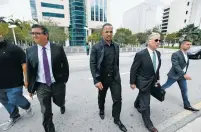  ?? WILFREDO LEE/THE ASSOCIATED PRESS ?? Chicago White Sox first baseman Jose Abreu, center, leaves federal court during a break Wednesday in Miami. Abreu has told a Miami federal jury he ate part of a fake passport while flying to the U.S. to cover up his illegal travel as part of a Cuban...