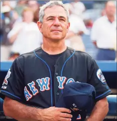  ?? Getty Images ?? New York Mets Manager Bobby Valentine holds his NYPD hat over his heart during the national anthem before the second game of a double-header against the Atlanta Braves on Sept. 11, 2002 at Turner Field in Atlanta, Ga.