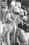  ?? By John Raoux, AP ?? Victor: A.J. Allmending­er gets a champagne shower at Daytona.