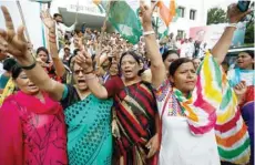  ?? — Reuters ?? Congress activists celebrate the victory of Ahmed Patel in Rajya Sabha polls, outside the party headquarte­rs in Ahmedabad, on Wednesday.