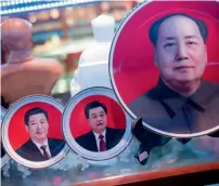  ?? AFP ?? Portraits of Chinese leaders are on display in a shop in Tiananmen Square as a key Communist Party meeting begins in Beijing. —