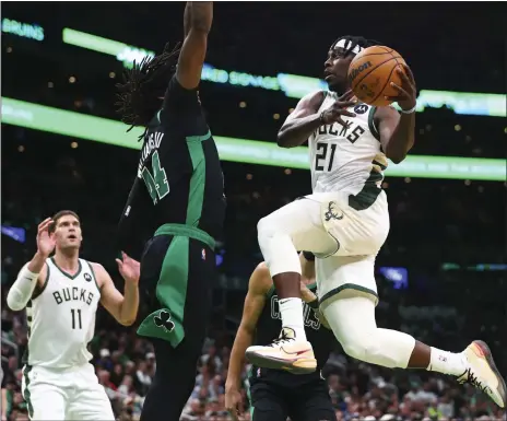  ?? GETTY IMAGES FILE ?? Robert Williams, seen attempting a block on Milwaukee’s Jrue Holiday in the Eastern Conference semifinals, has been in and out of the Celtics’ lineup
during the postseason but was available for Sunday night’s Game 7.