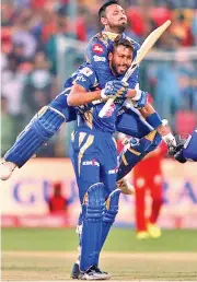  ?? — BCCI ?? Krunal Pandya celebrates with his brother Hardik after Mumbai Indians defeated Royal Challenger­s Bangalore in the group stage of the IPL.