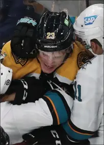  ?? NANCY LANE / BOSTON HERALD ?? Bruins forward Jack Studnicka gets in a tussle with San Jose Sharks’ Jacob Middleton and Andrew Cogliano on Sunday.